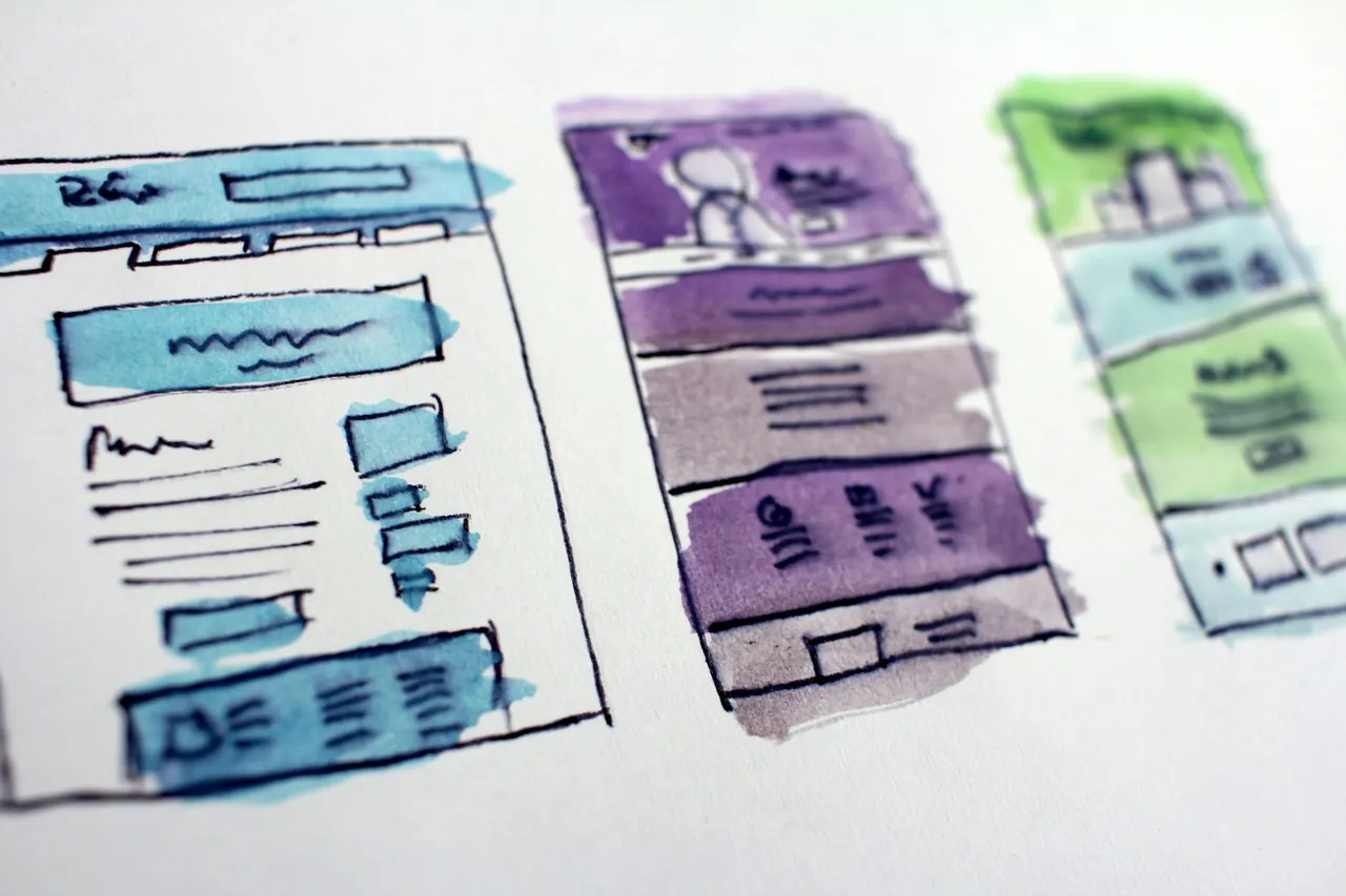 Hand-drawn watercolour wireframe sketches of website page layouts