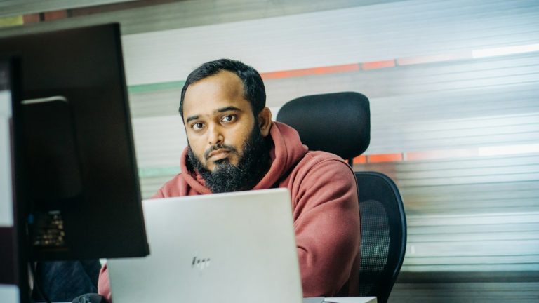 Cybersecurity professional reviewing website security on a multi-monitor workstation